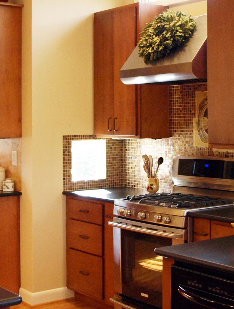 Window in backsplash floods countertop with light. 